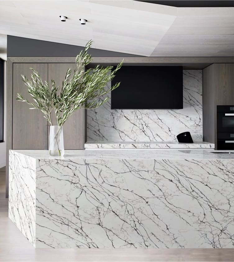 kitchen with an island decorated with white ceramicswith a gray wain pattern. Plan-It Stone, Best kitchen worktops in Bristol.