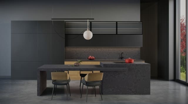 A Kitchen with a dark theme having a worktop fabricated from ceramics.
